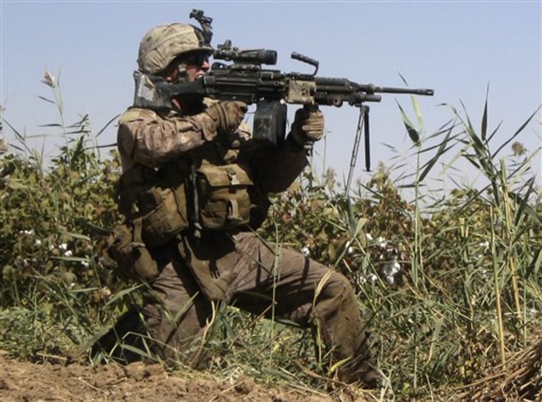 U.S. Marine Lance Cpl. Wesley Samuels, of Winter Haven, Fla., with the 2nd Battalion, 9th Marines' Echo Company, fires at Taliban insurgents in Marjah, Afghanistan in September. 